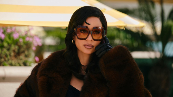 A still from Euphoria season 3 of actor Alexa Demie as Maddy wearing oversized sunglasses.